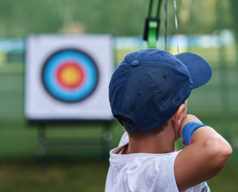 An elementary student learning archery safety for hunter education