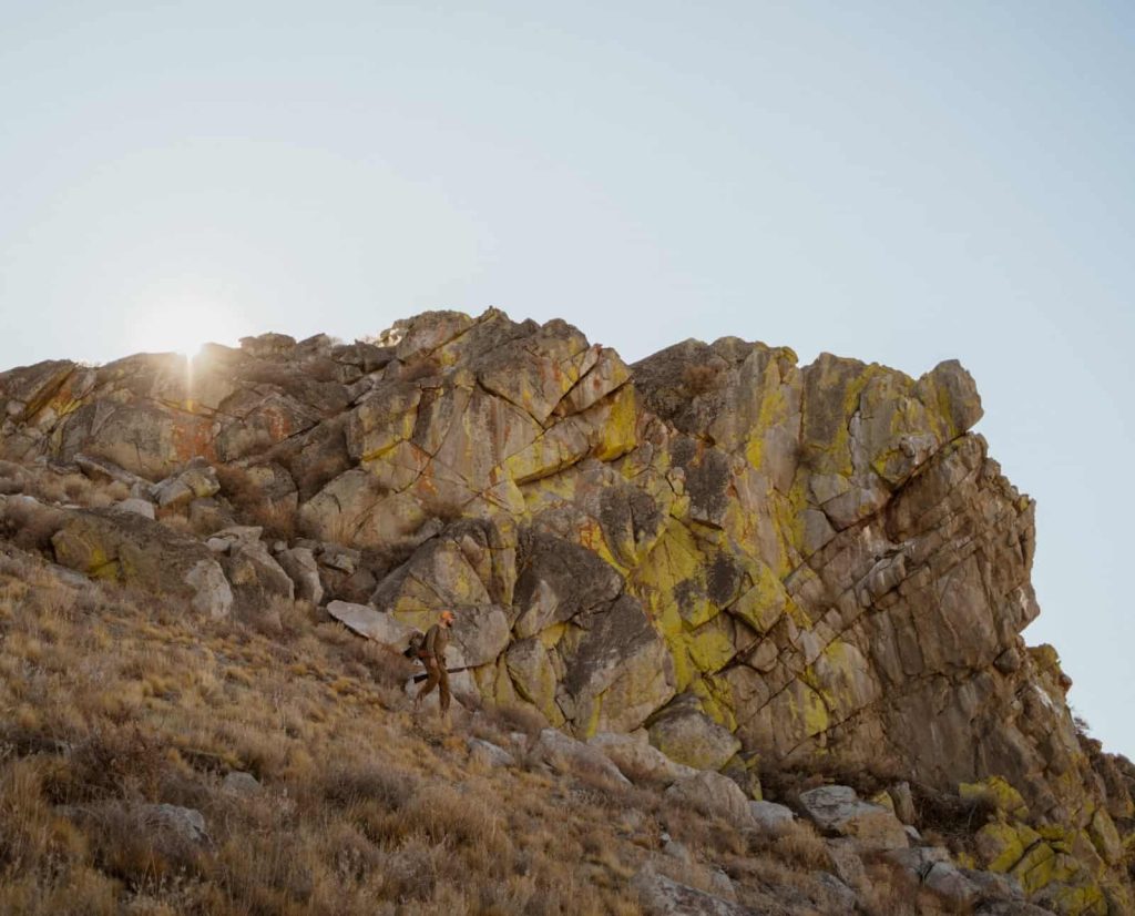 A chukar hunter walks through chukar habitat