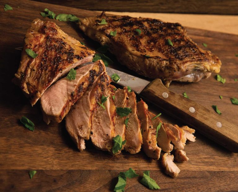 A cooked wild turkey breast carved for dinner serving