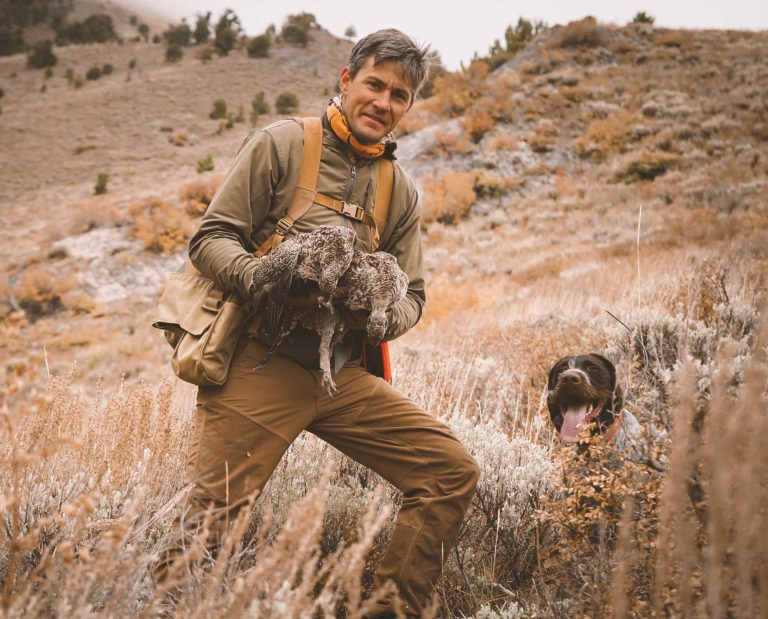 A bird hunter wearing a pair of First Lite Sawbuck Brush Pants