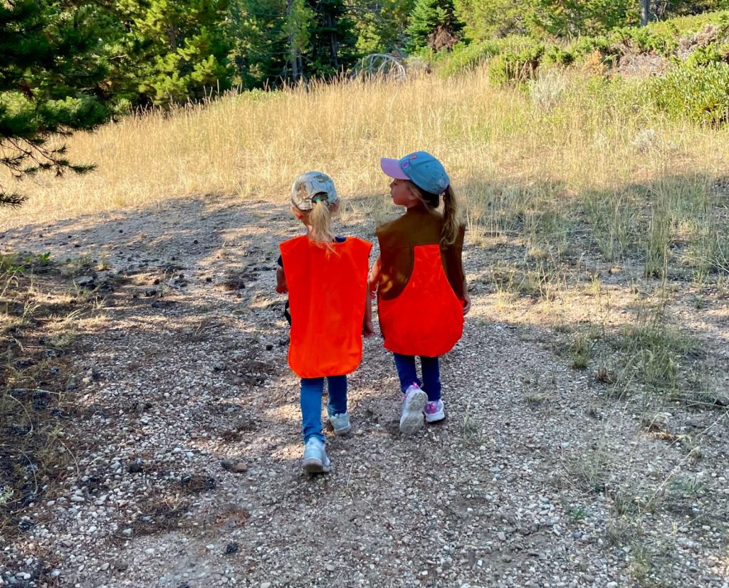 Two kids walking on a hunting trip