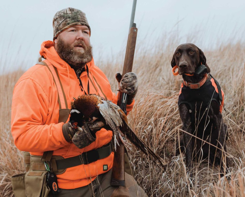 A pheasant hunter with his bird dog in Kansas.