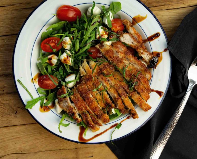 Crispy pan-fried pheasant breast served with an arugula and cherry tomato salad and a balsamic vinaigrette dressing.