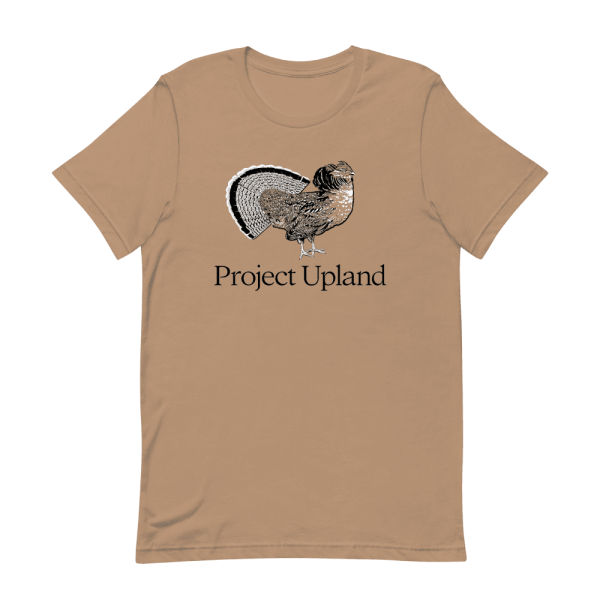 A fanning ruffed grouse on a Project Upland t-shirt in sand dune brown