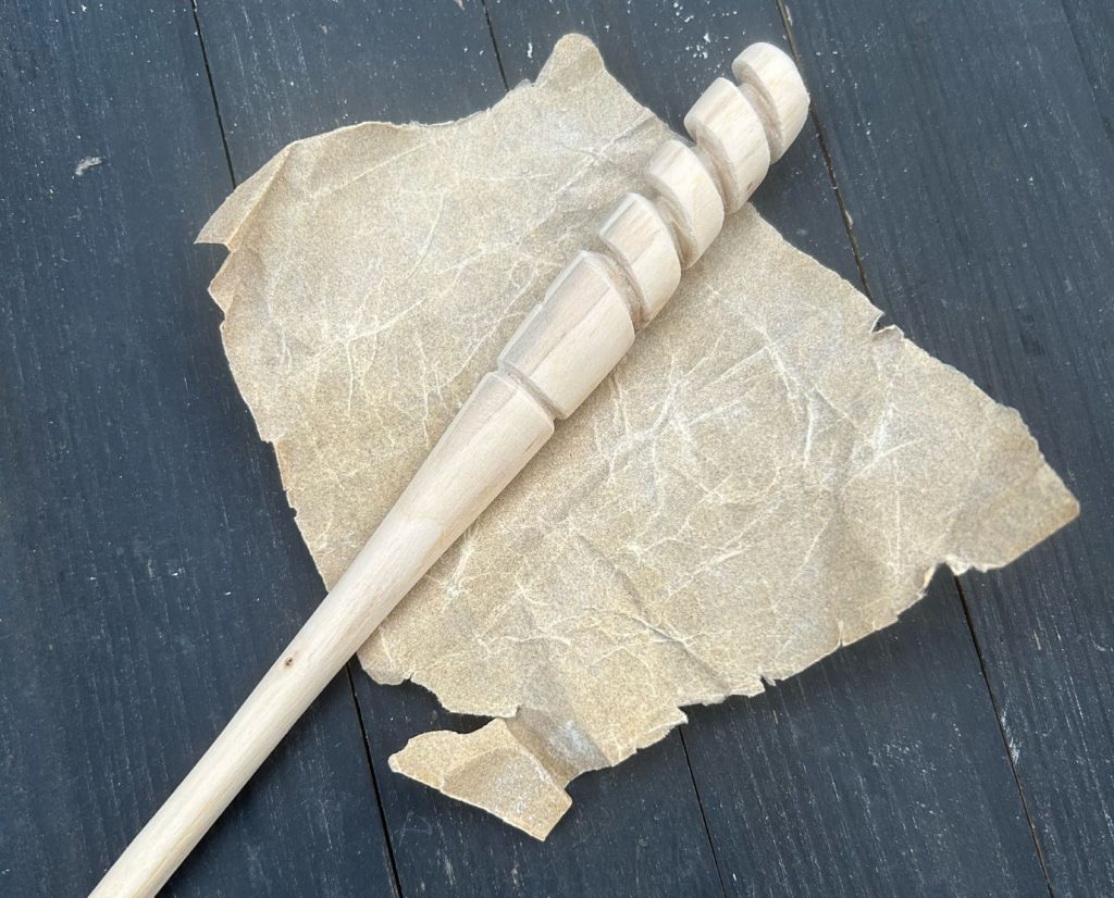 Sanding a turkey striker for finishing touches 