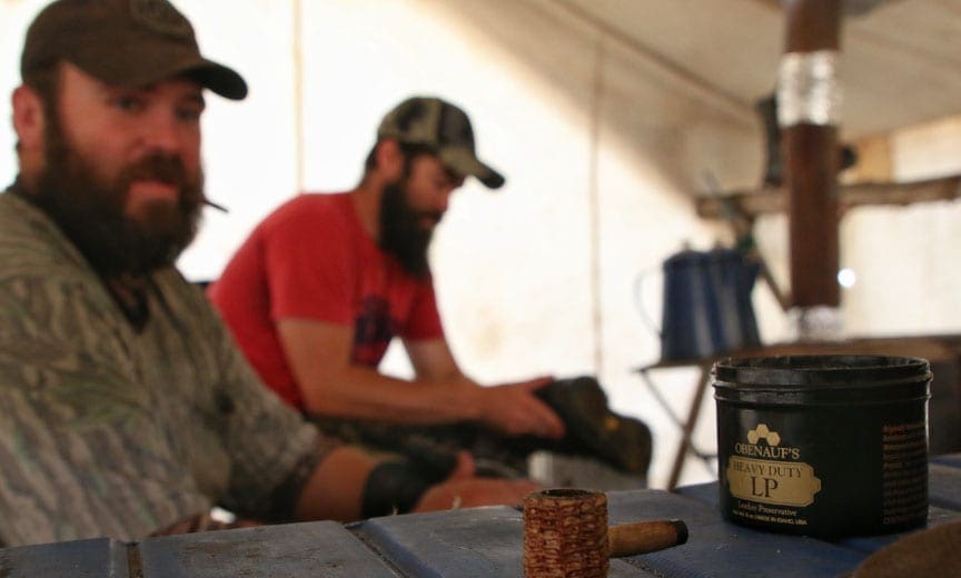 Hunters working on polishing their boots. 
