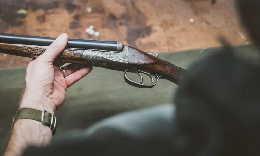 inspecting a vintage shotgun