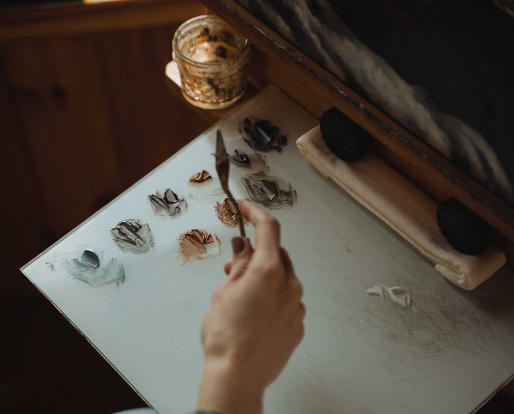 Amanda mixes paints in her studio