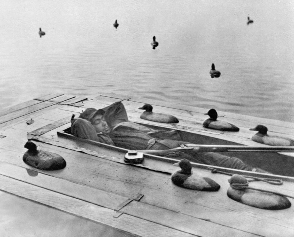 Example of a single cockpit sinkbox rig with iron and wooden wing decoys on the sinkbox deck