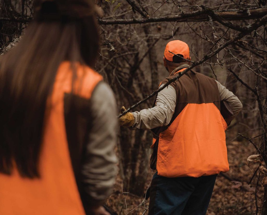 Amanda and her father walking up on a bird dog point.